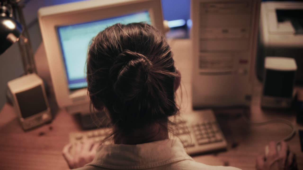 Man working and gaming on retro computer PC, IT engineer with vintage computer at home, using old fashion technology, close up of retro setup.