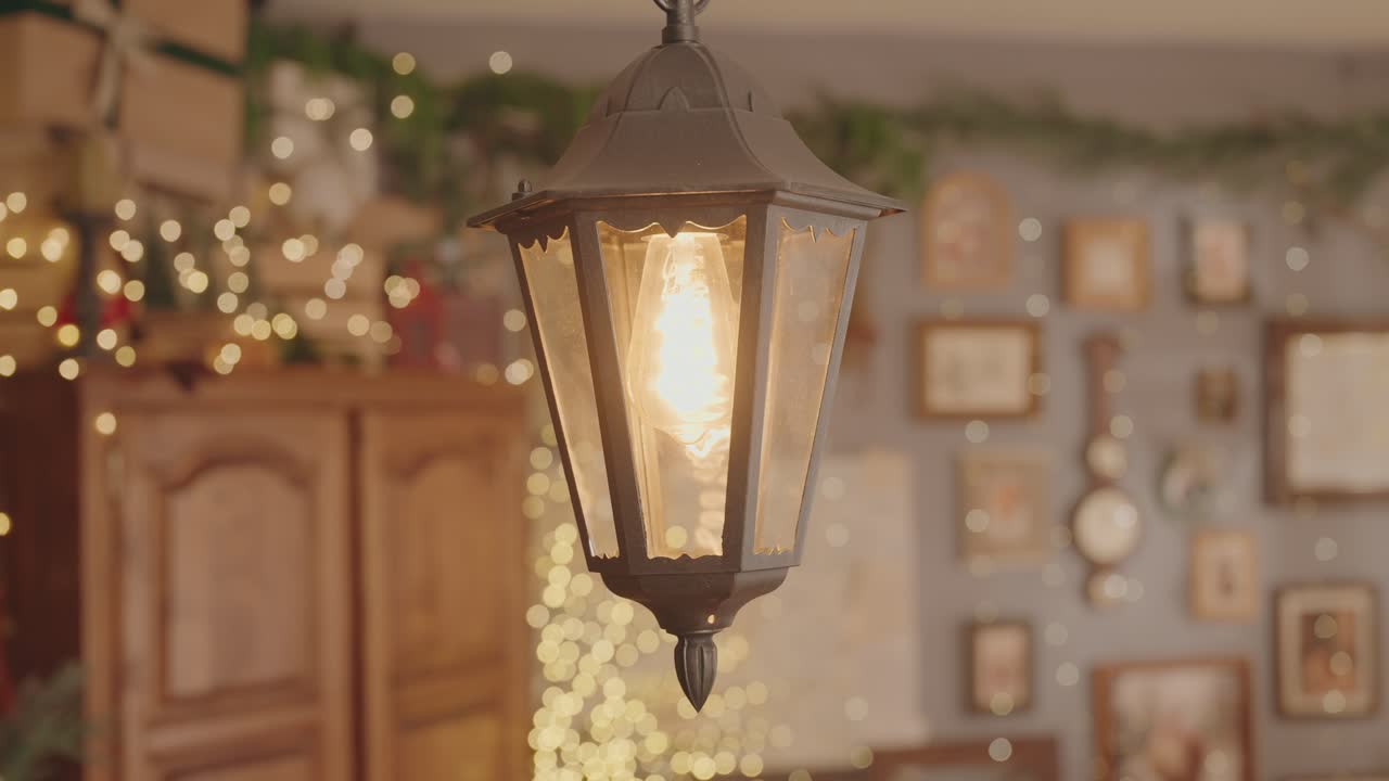 Close up of glowing lantern with festive bokeh lights and cozy decor
