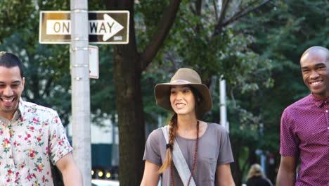 Group-Of-Friends-Walking-Along-Urban-Street-In-New-York-City