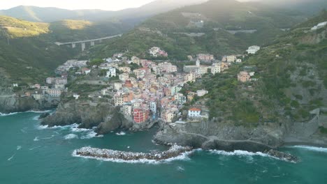 Cinematic-Establishing-Shot-Above-Riomaggiore,-Cinque-Terre-in-Italian-Tourist-Destination