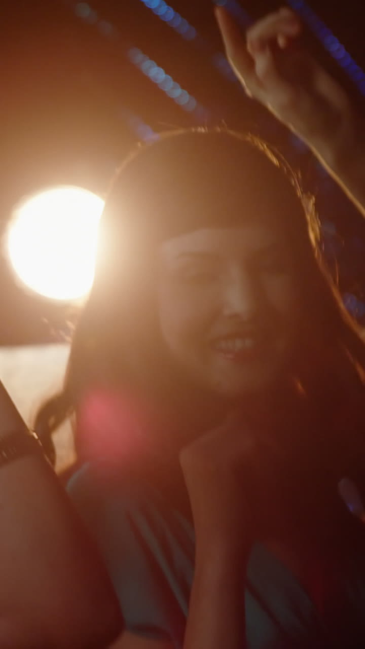 Group of smiling friends dancing on dance floor