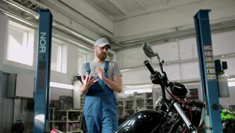 Man-with-cap-writing-at-the-garage