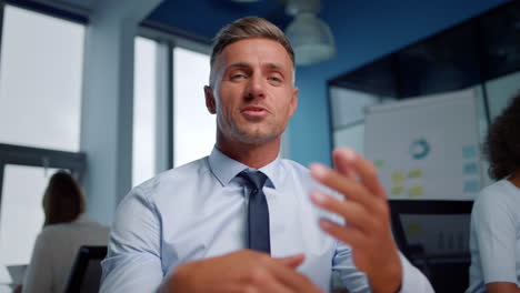 smiling business man having online conversation in open space