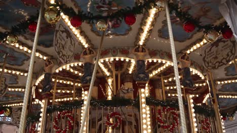 old traditional german carousel spinning in a market square at a festive christmas market in europe