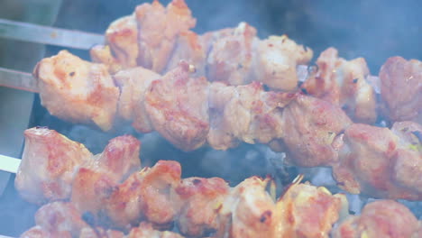 barbecue meat cooked on charcoal. woman tasting meat. grilling meat on barbecue