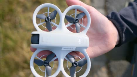 macro view of neo white new modern drone on palm of hand