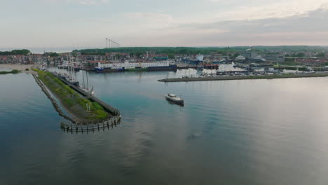 aerial dolly in shot of the luxemotor dutch boat leaves the port in holland