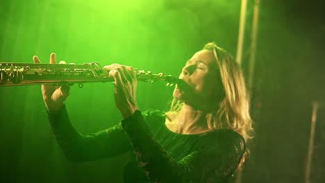 beautiful blonde woman playing a trumpet in a night club neon spotlights