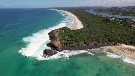 aerial view of fingal head with fingal head beach and dreamtime beach in nsw, australia - drone shot