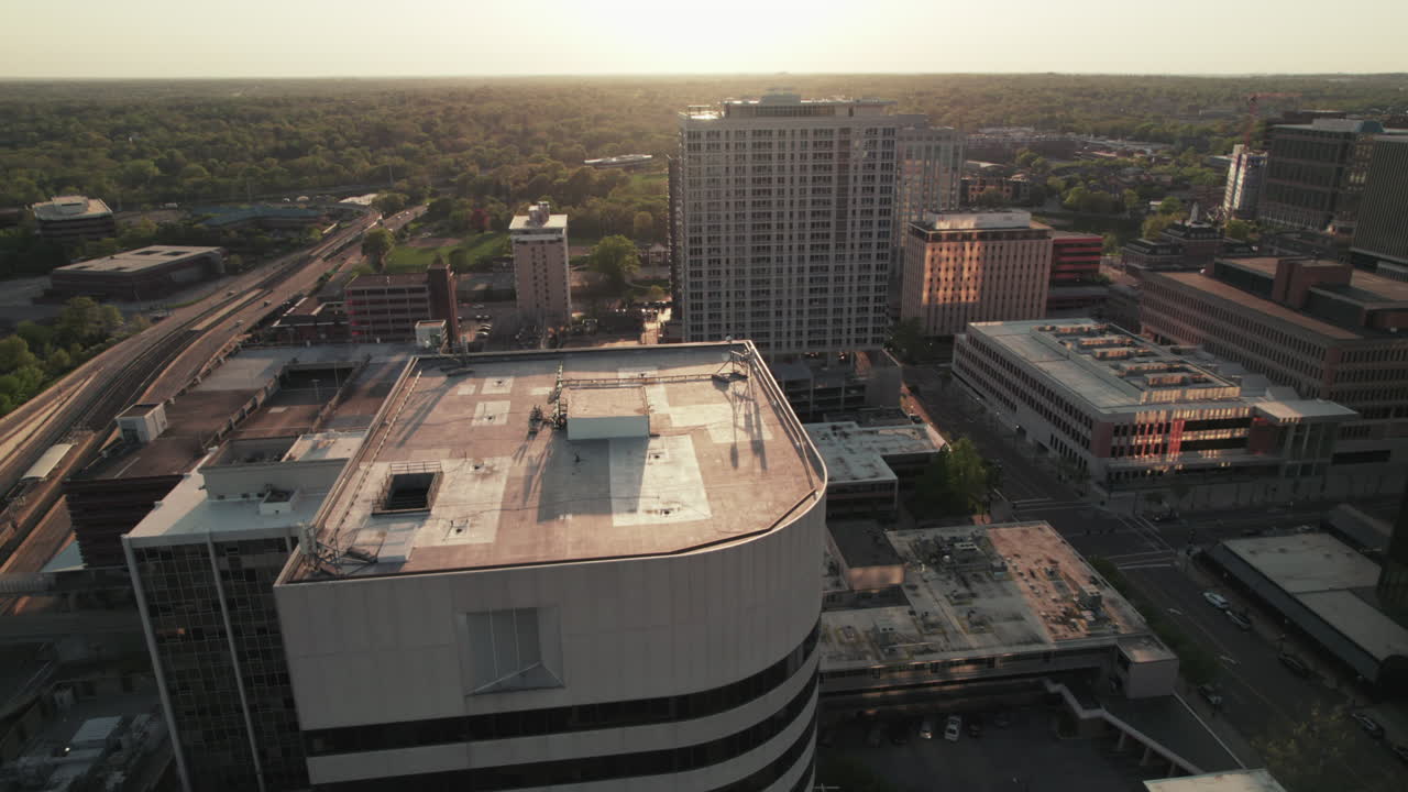 Aerial sliding shot at sunset golden hour past buildings of Clayton, Missouri.