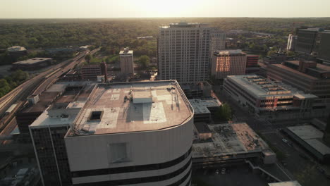 aerial sliding shot at sunset golden hour past buildings of clayton, missouri.