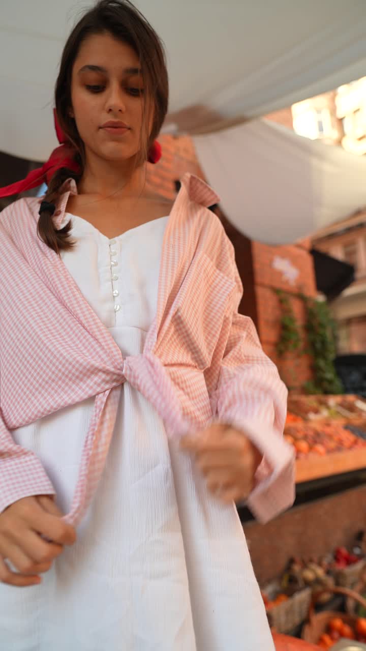 분홍색과 색의 클레이드 옷을 입은 젊은 여성