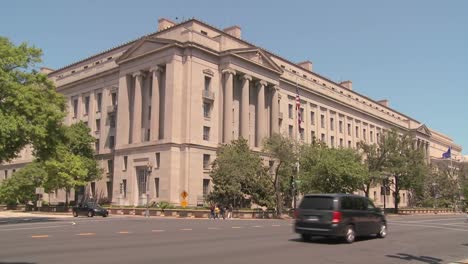 the national archives building in washington dc with traffic passing 1