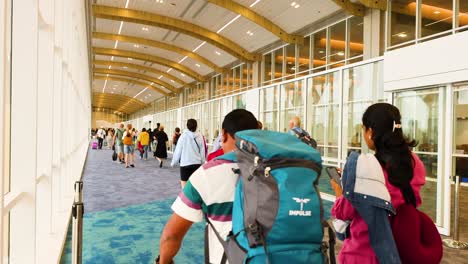 people walking with luggage in airport terminal