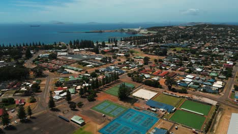 aeral revealing the city of esperance in western australia with tennis fiels in the foreground and the harbour in the background on a sunny day