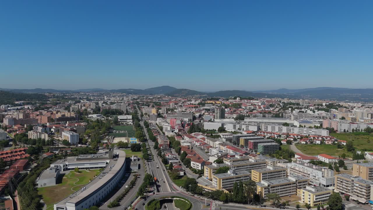 Aerial view of Braga's cityscape featuring diverse buildings, roads, and sprawling green areas