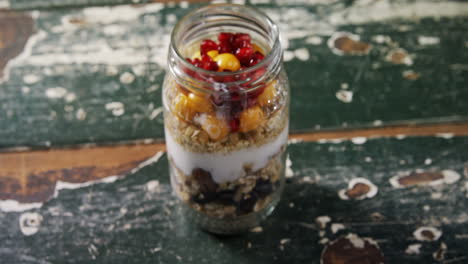 yogurt with pomegranates and golden berries in glass jar 4k