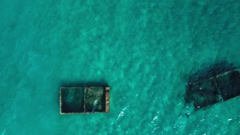 Sensational-aerial-top-down-view-of-underwater-tubs-surround-by-turquoise-water