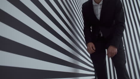man in a suit interacting with optical illusion display
