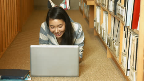 student reading a book in the library