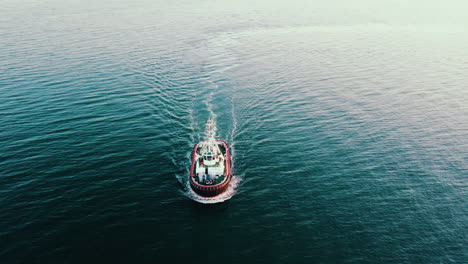 Drone-flying-over-the-fishing-vessel-sailing-on-the-Baltic-Sea-at-the-sunset