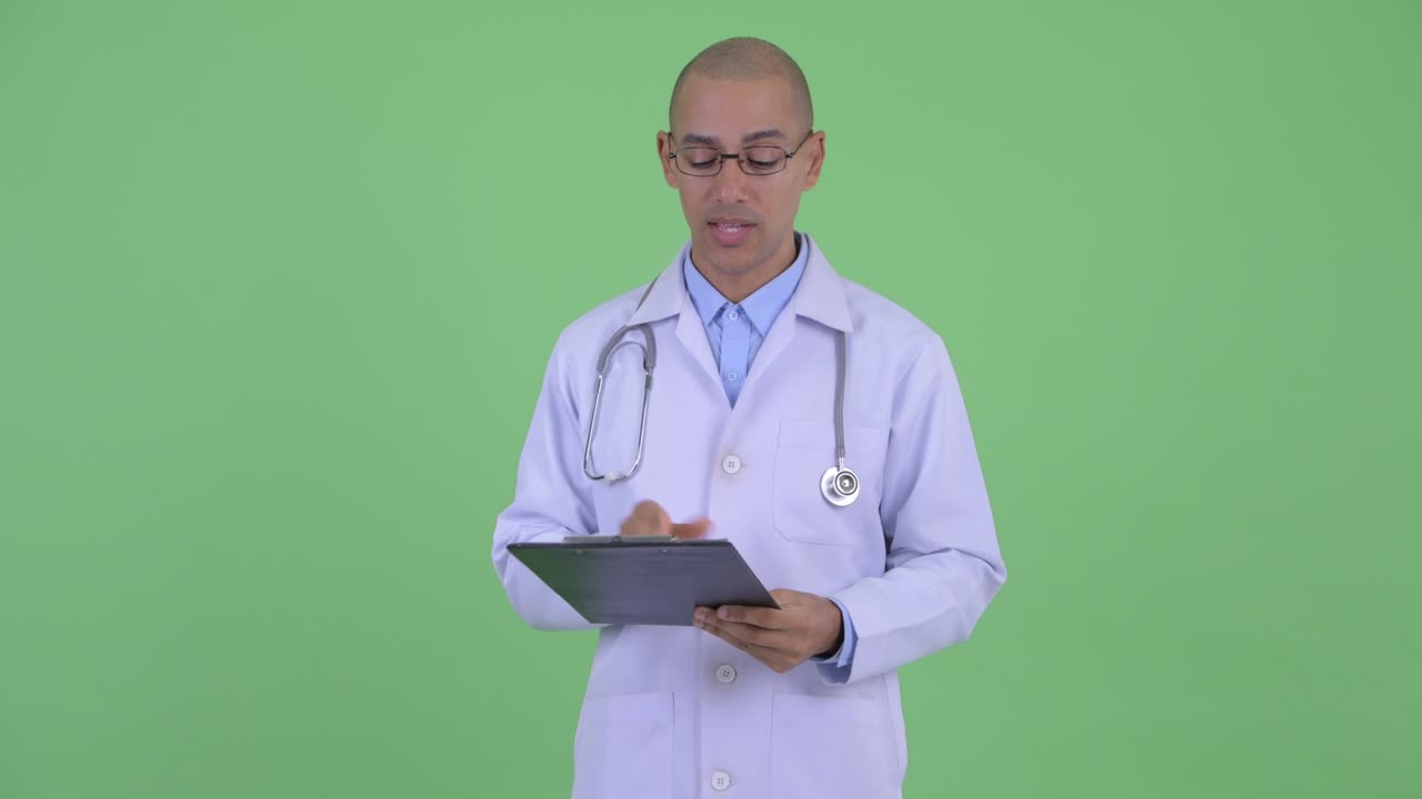 Handsome bald multi ethnic man doctor with clipboard