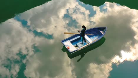 Woman-on-the-boat-catches-a-fish-on-spinning-in-Norway.