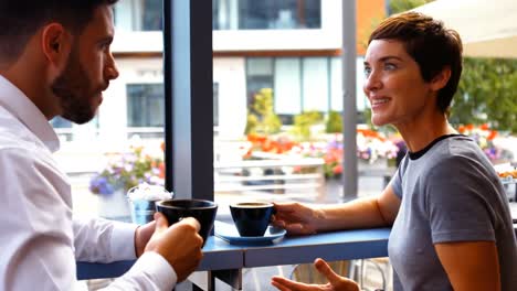 Businesspeople-interacting-while-having-coffee