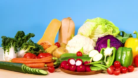 assorted vegetables displayed against a blue backdrop