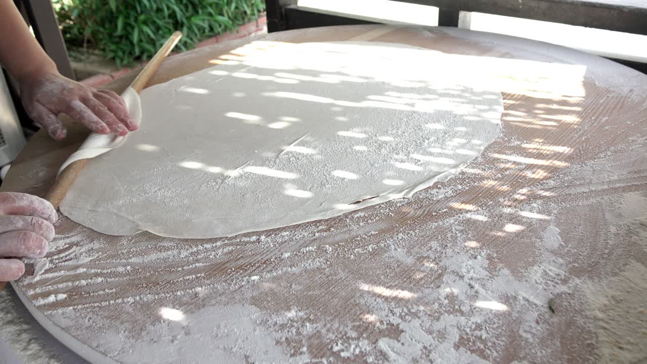 Turkish flatbread. Close - up cook prepares delicious cakes with stuffing.