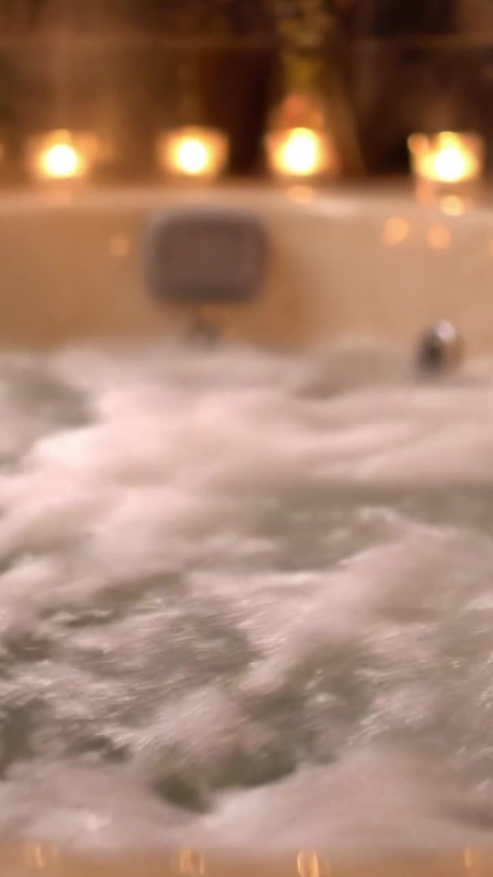 A Relaxing Evening in a Warm Bath with Bubbles and Soft Candlelight, Perfect for Unwinding After a Long Day