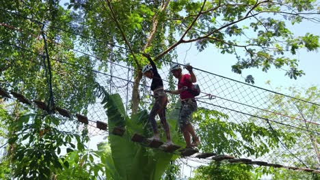 couple enjoying a challenging treetop adventure park experience