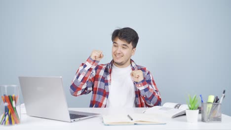 man looking at laptop applauding.