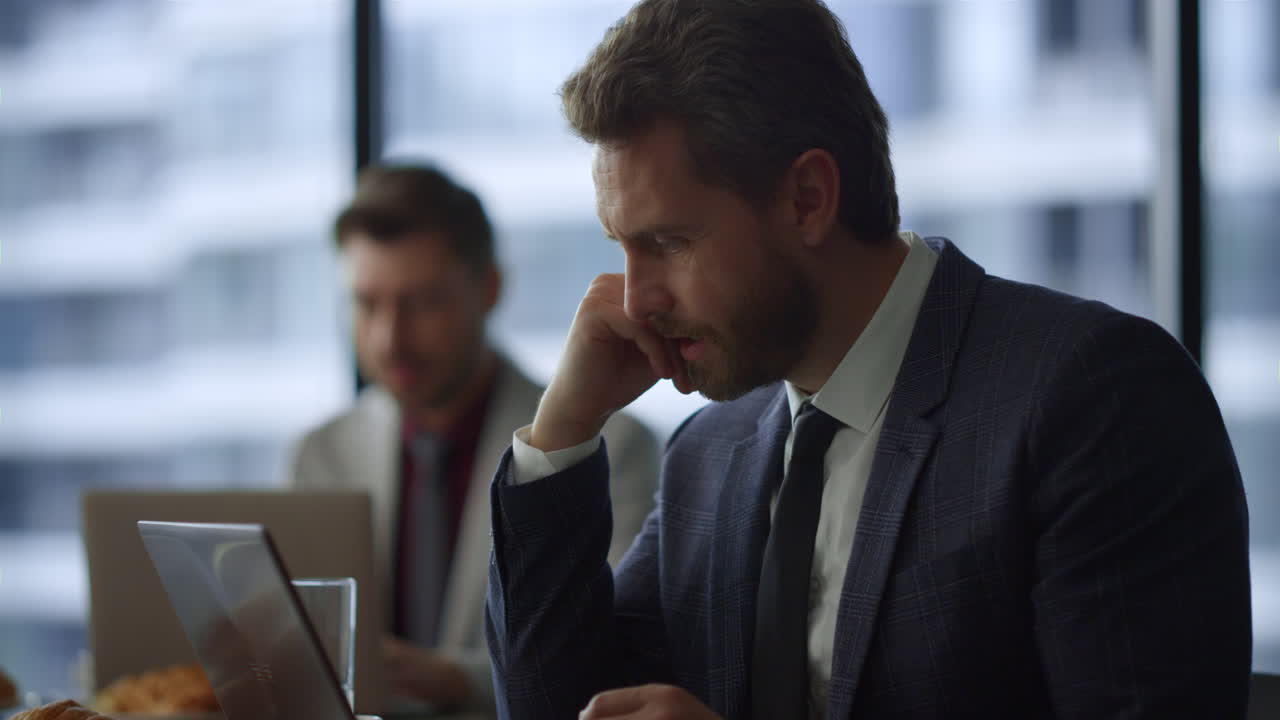 Thinking entrepreneur looking computer screen solving problem in cafe office.