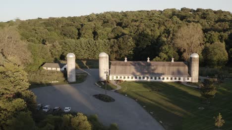 old historic barn and silo towers in orbiting aerial view