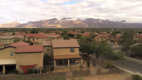 cinematic drone shot of homes and mountains in tucson arizona