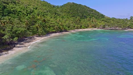 Remote-paradise-beach-with-turquoise-blue-water-in-the-Caribbean-rainforest