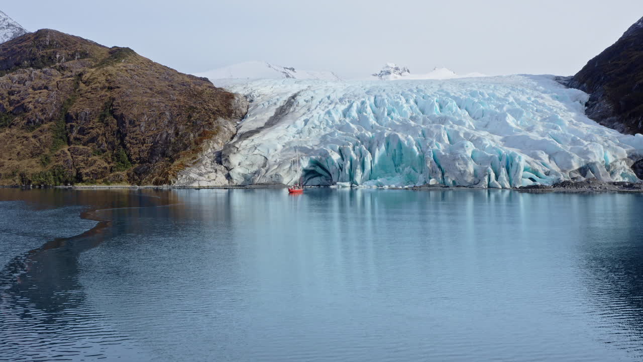 Dramatic Scenery Of Mountains With Ice Formations Through Beagle Channel In Argentina. Aerial Drone Shot