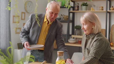 Elderly-Couple-Preparing-Dinner-Table-Together