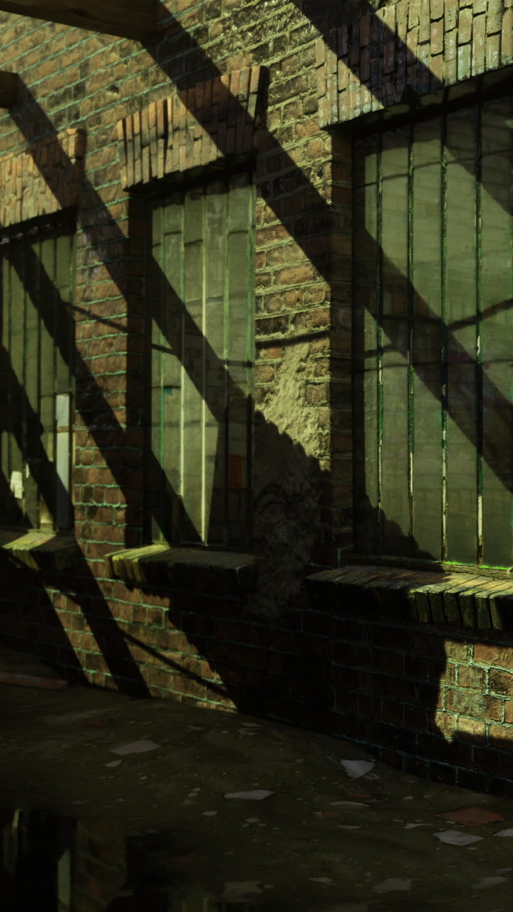 Shadows and sunlight play on brick walls and windows during the afternoon