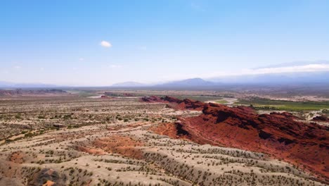 Drone-shot-flying-over-an-interesting-rock-formation-to-reveal-the-Reserva-Banda-Florida-in-La-Rioja,-Argentina