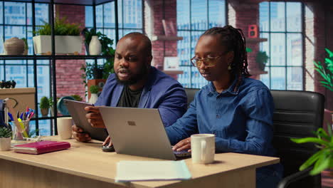 african american man and woman focused on their freelancing work