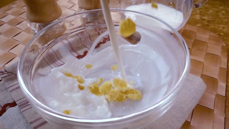 Crispy-yellow-corn-flakes-into-the-bowl-for-the-morning-a-delicious-Breakfast-with-milk.-Slow-motion-with-rotation-tracking-shot.