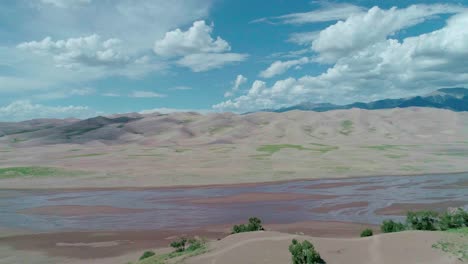 Drone-view-of-a-low-river-with-mountains-in-the-background