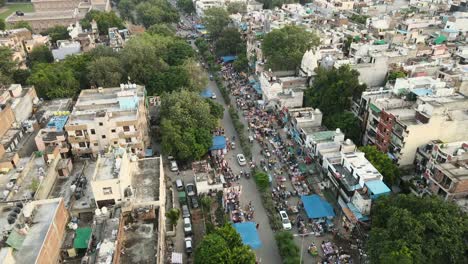 4k aerial shots of a local market in new delhi residential suburbs on a beautiful day gliding over rooftops, streets, parks and markets in india