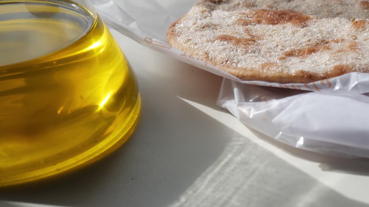 Sugared biscuit with olive oil in sunlight, traditional and rustic food concept