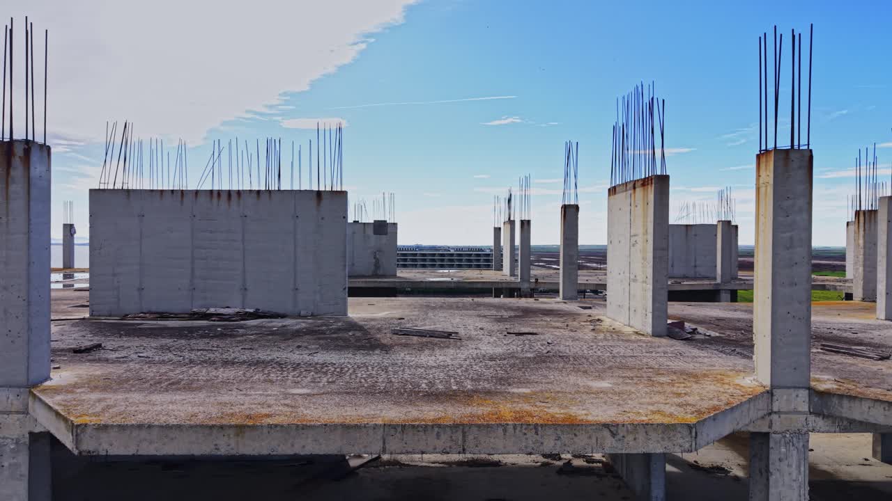 Aerial view of construction site with building foundations near water