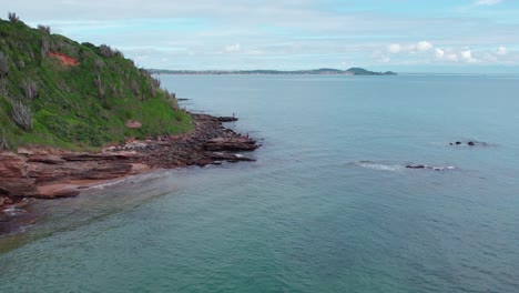 Aerial-view-of-three-fishermen-fishing-on-Tartaruga-beach-coastline