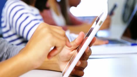 student using digital tablet in classroom