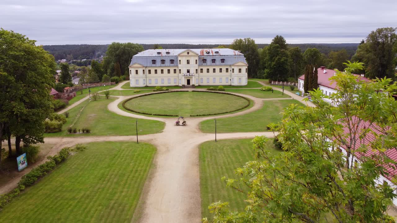 Majestic manor of Kraslava with green grass and circle road, aerial view